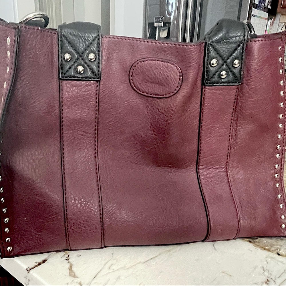 Beautiful bag in eggplant wine color, leather with studs. Medium size tote.